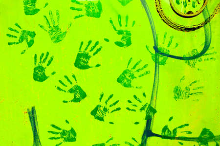 Green handprints on the metal surface.の写真素材