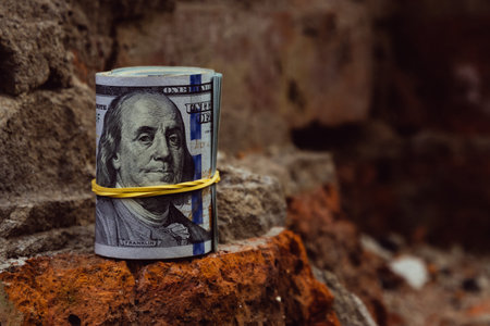 American dollar on the bricks of an old broken house, close-up.