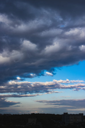 Dramatic dark cloudy sky over the horizon, natural blue background.