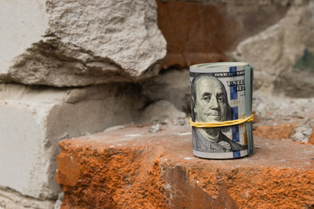 American dollar on fragments of old red and white bricks, close-up.の写真素材