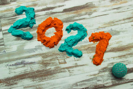Bright colored sand plasticine 2021 on a gray stripe background.の写真素材