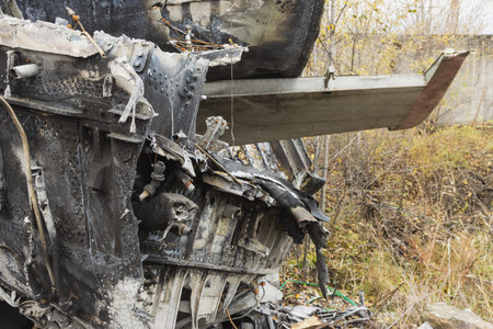 Plane wreckage, parts of the fuselage and tail of the burned and broken aircraft at the dump of...