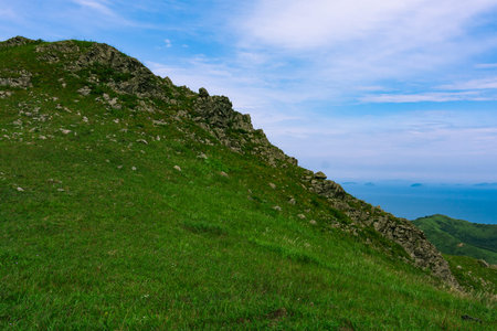Rocks on top of a hill, summer sea background.の写真素材
