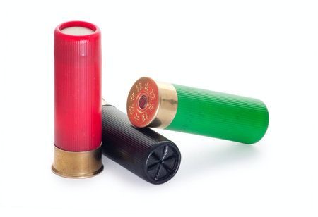 Three multi-colored cartridges for a smooth-bore hunting rifle 12 caliber (isolated on a white...