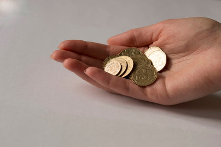 Hand with gold coinsの写真素材