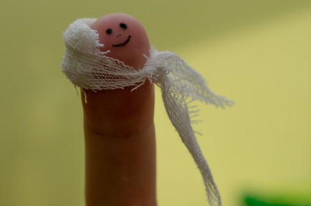 smile face on the finger, with bandage.の写真素材