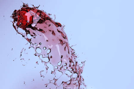 Wine or juice splash in studio with reflectionsの写真素材