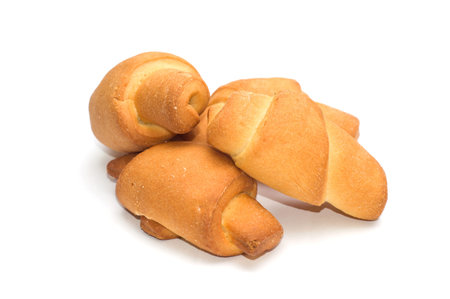Fresh appetizing crescent rolls on a white background