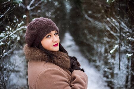 Portrait of a beautiful girl in a coat and beretの写真素材