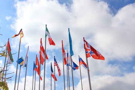 Flags of different countries on the background of the blue skyの写真素材
