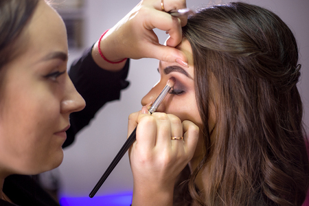 Make-up artist makes make-up an attractive modelの写真素材
