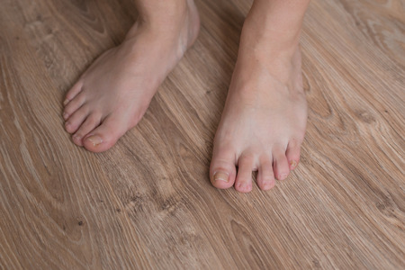 wooman feet on the wooden floorの写真素材