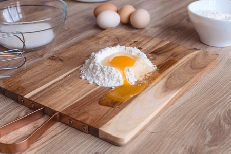 broken egg in flour on cutting board