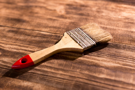 paintbrush on  burnt wooden backgroundの写真素材