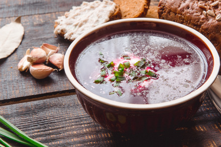 soup with onions and slices of bread on a dark wooden backgroundの写真素材
