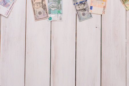 money from different countries attached to the rope clothespinsの写真素材