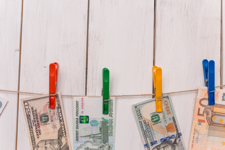 money from different countries attached to the rope clothespins
の写真素材