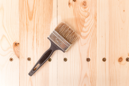 brush with the varnish on a wooden tableの写真素材