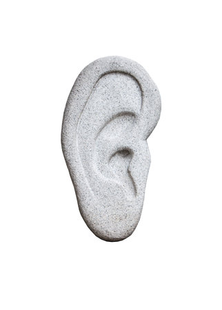 human ear made of stone on white backgroundの写真素材