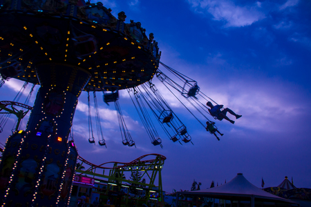 Beautiful, young couple having fun at an amusement parkの写真素材