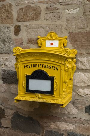 old rusty mailbox on the timbered wallの写真素材