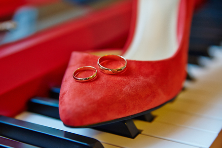 wedding rings, bridal shoes piano keys backgroundの写真素材