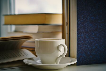 Cup of tea and books, close upの写真素材