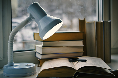 still life of lamps, books, notebook and penの写真素材