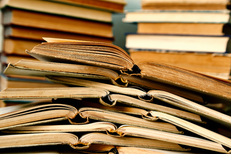pile of open books lying on each otherの写真素材