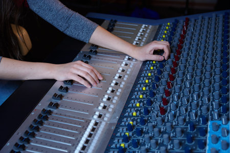 An expert adjusting audio mixing consoleの写真素材