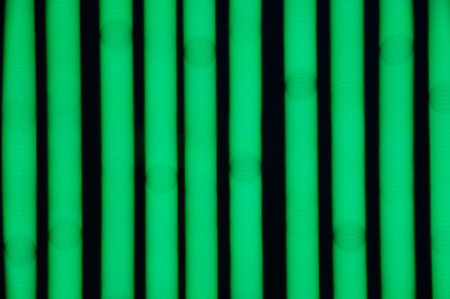 Bokeh background of green LED strips on black backgroundの写真素材