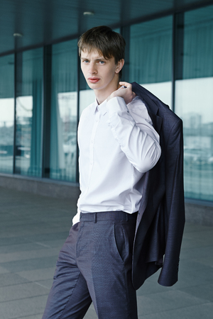 Young and handsome man wearing his jacket over shoulderの写真素材