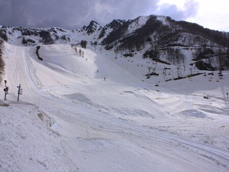 Snowy empty mountain ski gentle slope. Rosa Khutor, Sochi, Russia.の写真素材