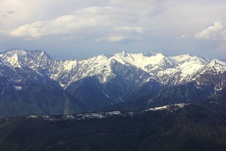 Mountain landscape. Mountain chain with snowy peaks. Mountain valley in cloudy weather. Sochi, Russia.の写真素材
