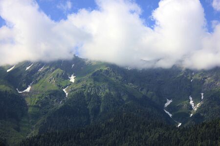 Summer landscape. High green mountain range in the clouds.の写真素材