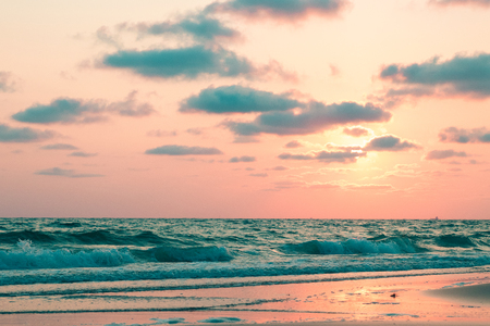 Beautiful pink sunset over sea on the beach, background.の写真素材