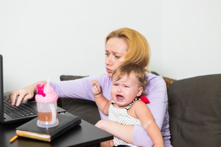 mom freelancer works. child interferes. freelancing problems.の写真素材