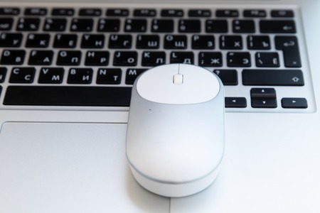 White computer mouse on the keyboard. Place for logo and textの写真素材