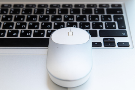 White computer mouse on the keyboard. Place for logo and textの写真素材