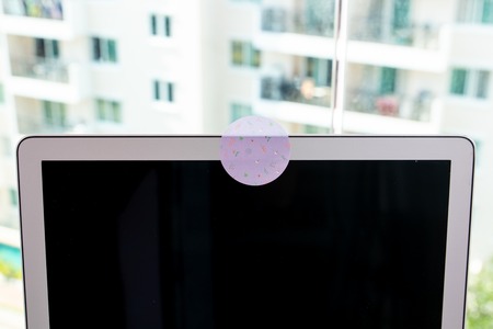 Close up blocks the covered webcam with a white sticker tape.の写真素材