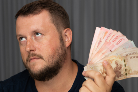 Businessman hand grabbing money, Thai Baht. transfer money.の写真素材