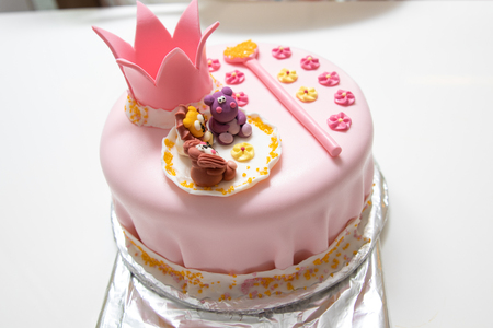 pink cake of a little princess with a crown and animal figures. Birthday one year old. holiday conceptの写真素材