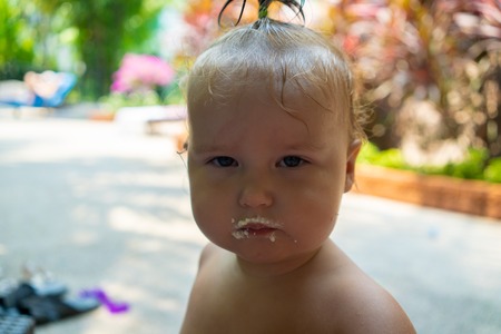 Girl one year old portrait of a child smeared with food. cute kids food conceptの写真素材