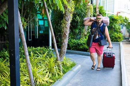 male travels with a lot of bags and luggageの写真素材