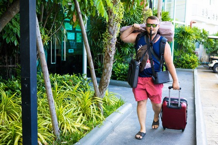 male travels with a lot of bags and luggageの写真素材