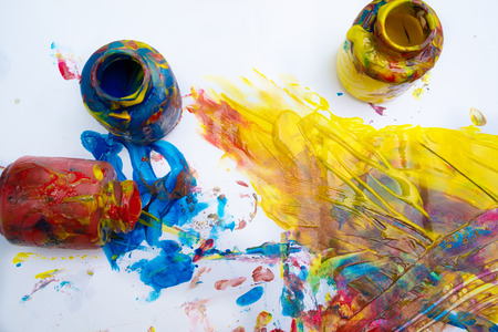 Finger paints - blue, red and yellow on a white sheet of paper. Creative child development in kindergarten or free time at home.の写真素材