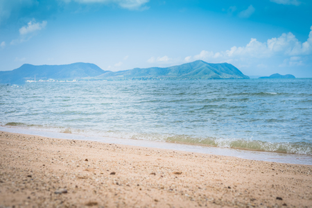 Tropical beach view. Calm and relaxing empty beach scene, blue sky and white sand. Tranquil nature conceptの写真素材