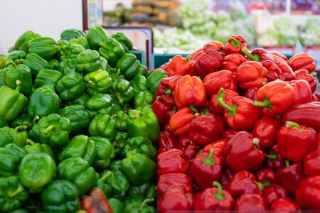 Red and Green Peppers. Displayed on a market stallの写真素材