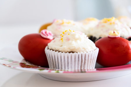 Easter bread cake and painted red eggs on a plateの写真素材