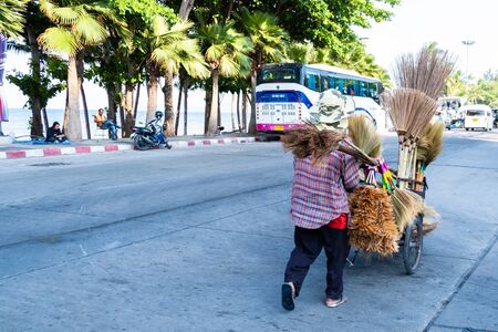 Pattaya, Thailand - May 27, 2019: Unidentified woman sells brooms on a streetのeditorial素材
